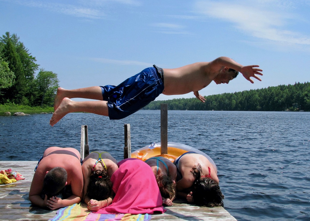Boy diving over his friends