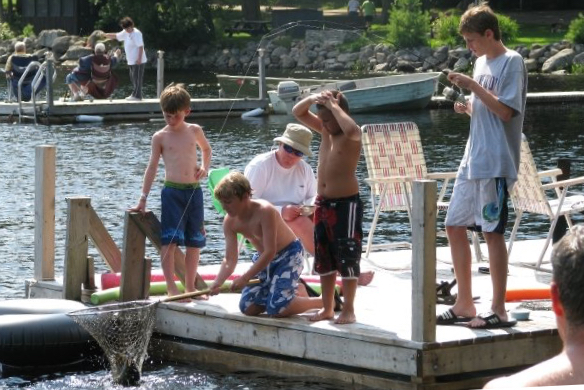 Kids catching a fish from the dock